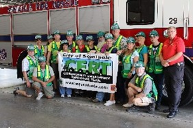 Photo of CERT members in front of a firetruck