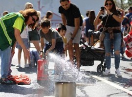Photo of CERT member with kids at fire station open house event
