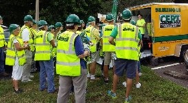Photo of CERT members gathered in front of CERT trailer