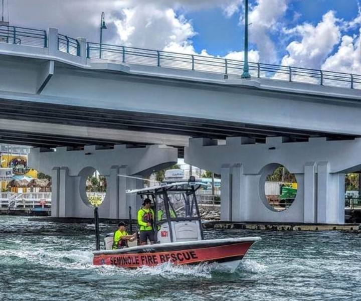 Seminole Fire Rescue boat on the water going under bridge