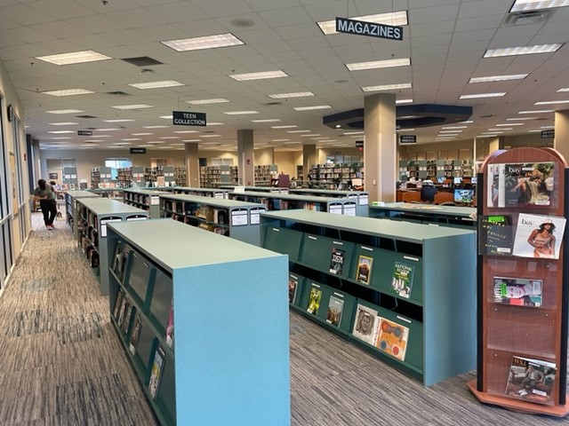 Adults using laptops at the library