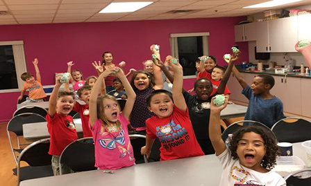 Kids holding up slime